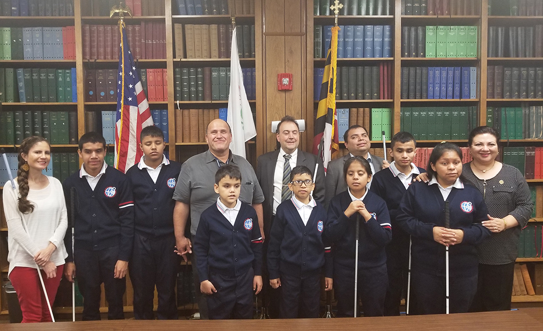 Members of the Voices of Light Choir pose with President Riccobono, Gabe Cazares, and Conchita Hernandez at the Jernigan Institute